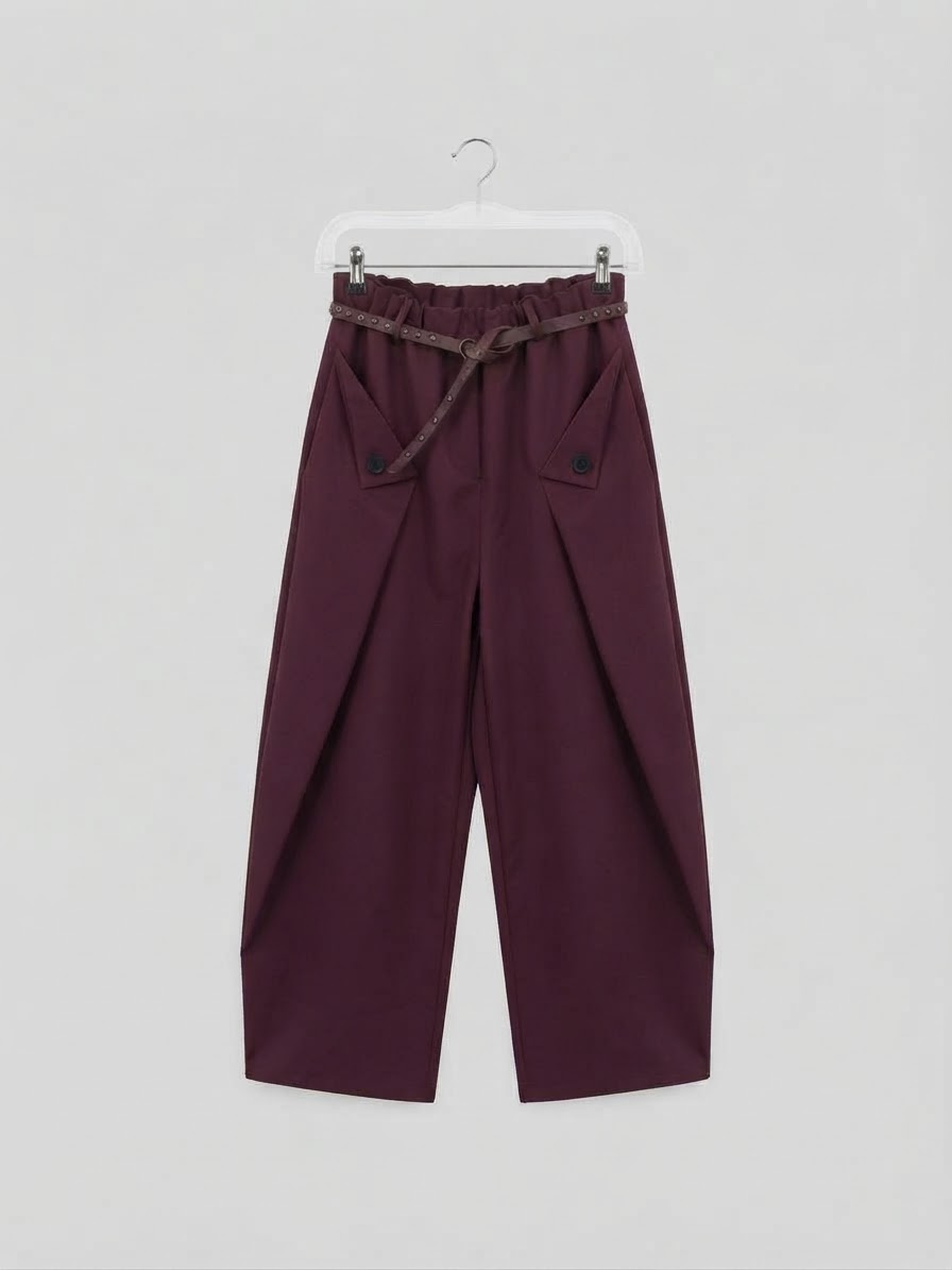 Pantalone a palloncino con pieghe e cintura borchiata